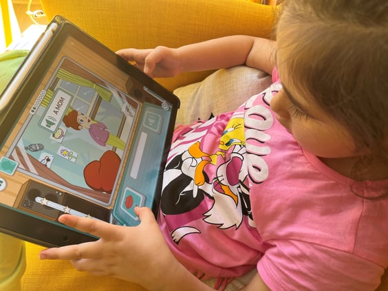 Child using the Moomin Language School application on a tablet