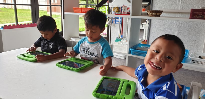 Guatemalan children using Moomin Language School on tablets