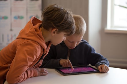 Two kids using a tablet