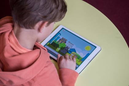 A young boy uses Moomin Language School on a tablet