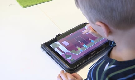 A child using Moomin Language School on a tablet