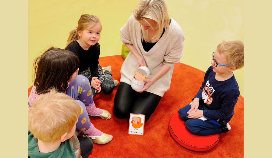 A group of children with their kindergarten teacher are learning social and emotional skills