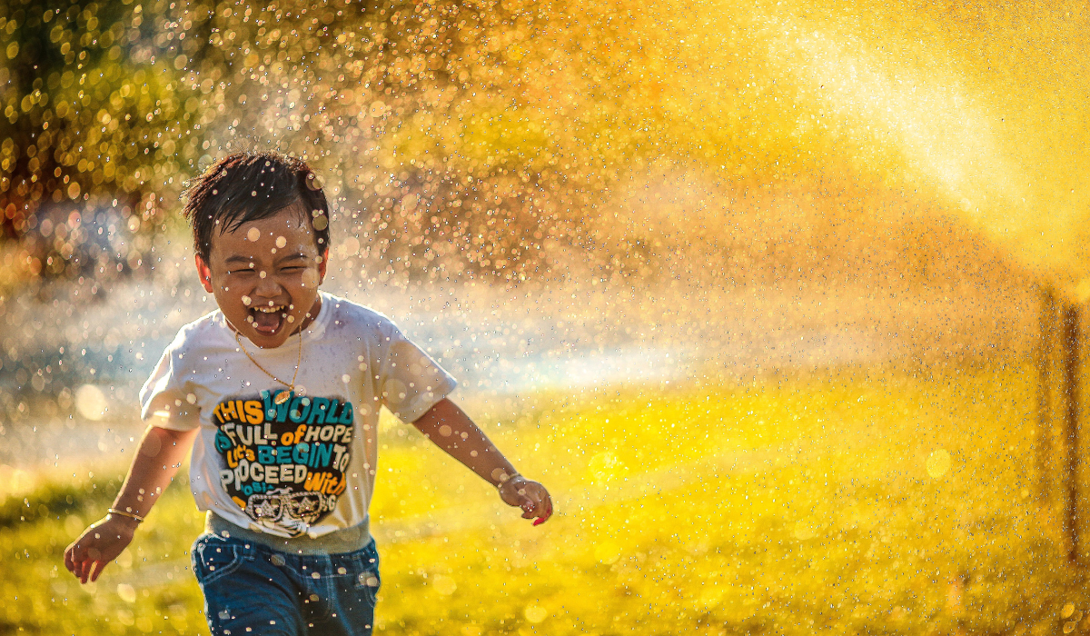 Happy child running through rain