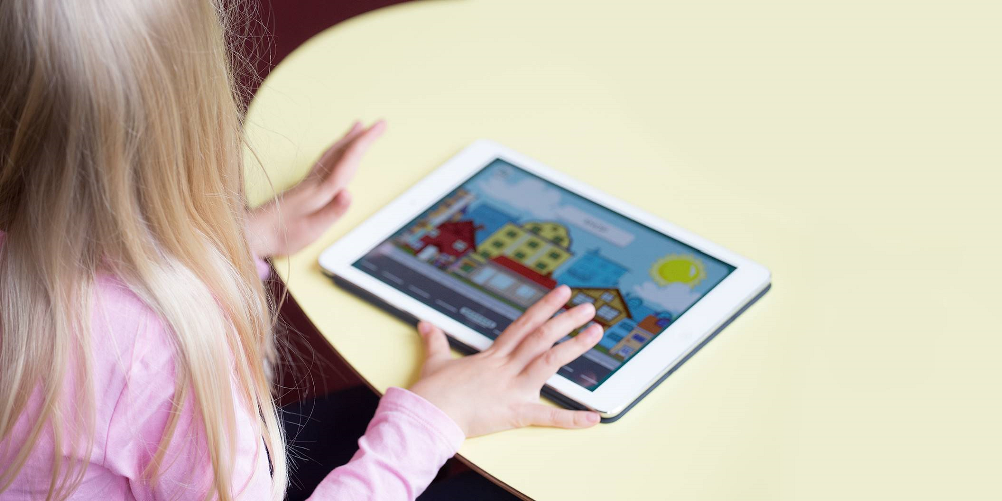 Child using the Moomin Language School application on a tablet